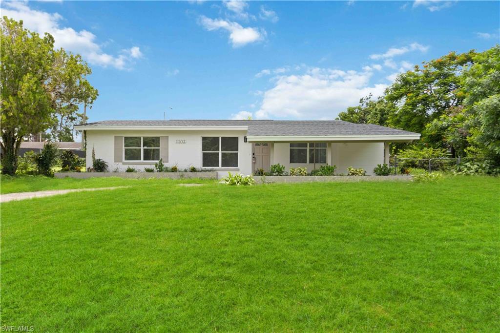 a front view of house with yard and green space
