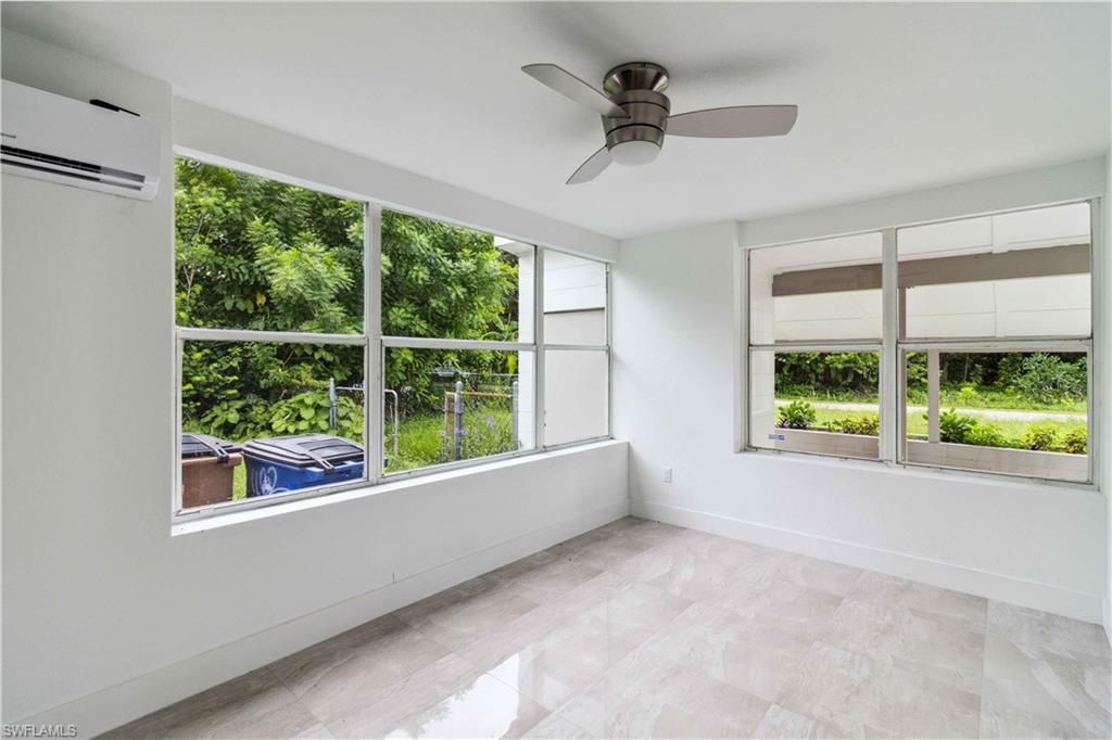 1102 East Bougainvillea Road Lehigh Acres, FL 33936 - Photo 12 of 28 a view of room with window and a ceiling fan