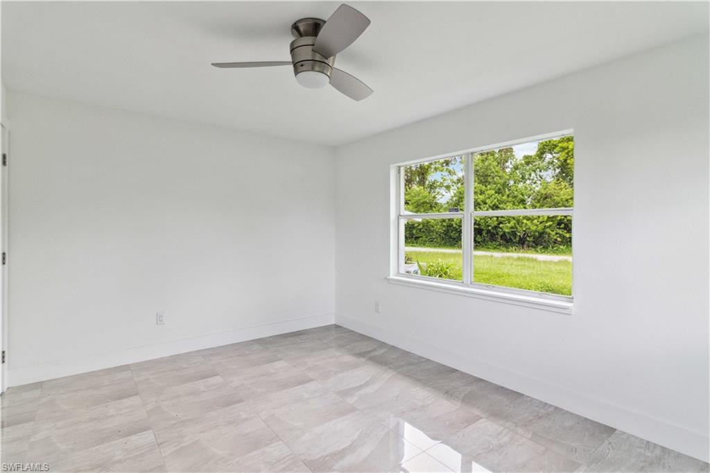 1102 East Bougainvillea Road Lehigh Acres, FL 33936 - Photo 18 of 28 a view of an empty room with a window