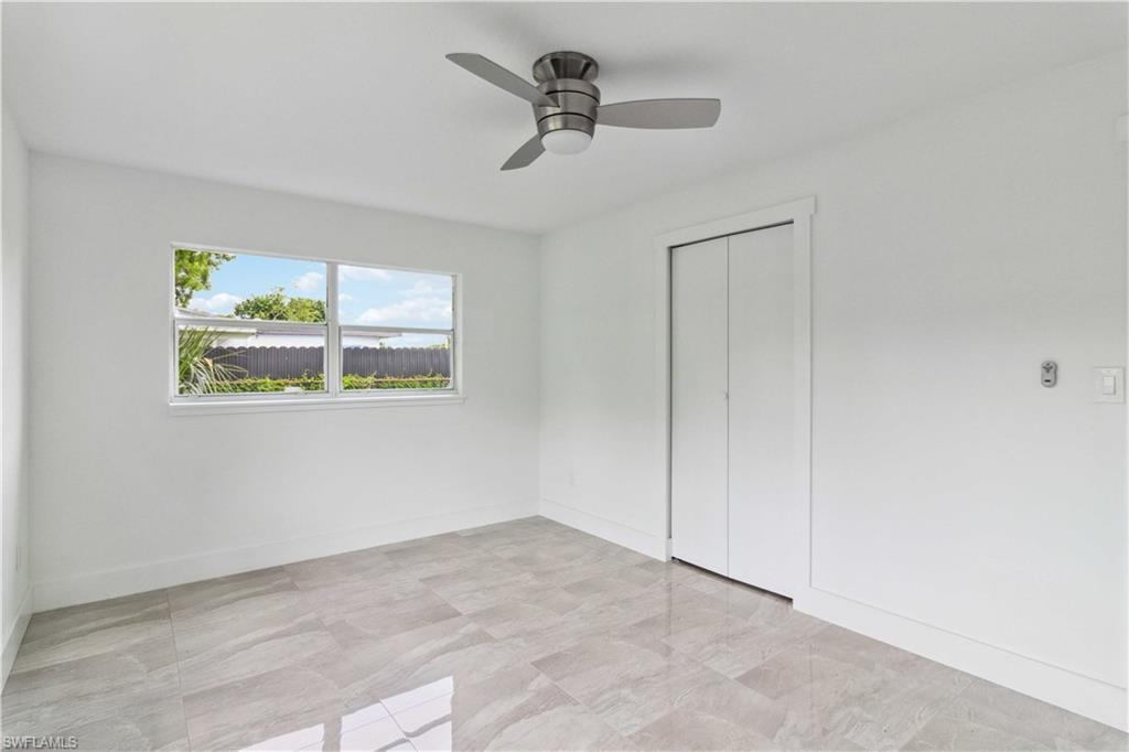 1102 East Bougainvillea Road Lehigh Acres, FL 33936 - Photo 20 of 28 an empty room with cabinet and ceiling fan
