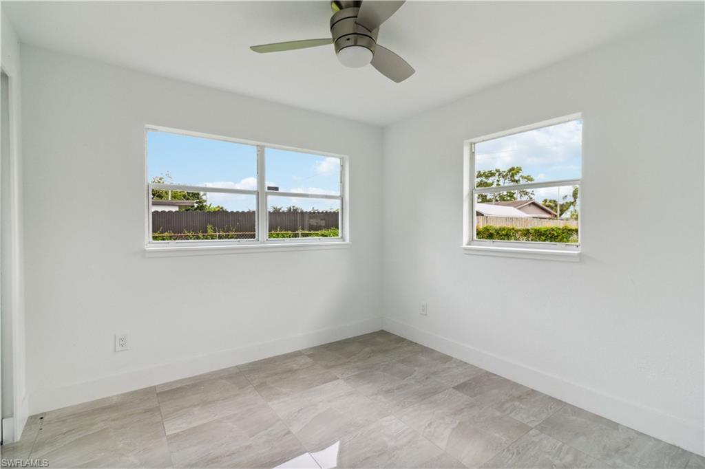 1102 East Bougainvillea Road Lehigh Acres, FL 33936 - Photo 21 of 28 an empty room with a window and a ceiling fan