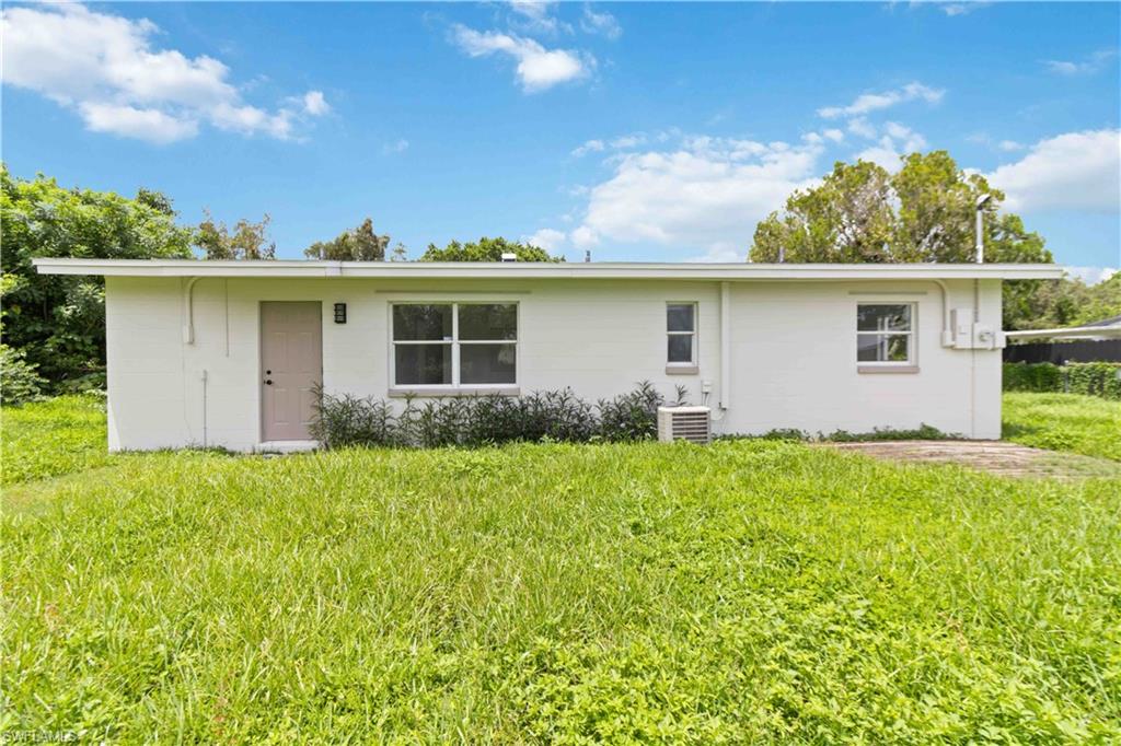 1102 East Bougainvillea Road Lehigh Acres, FL 33936 - Photo 27 of 28 front view of house with a yard