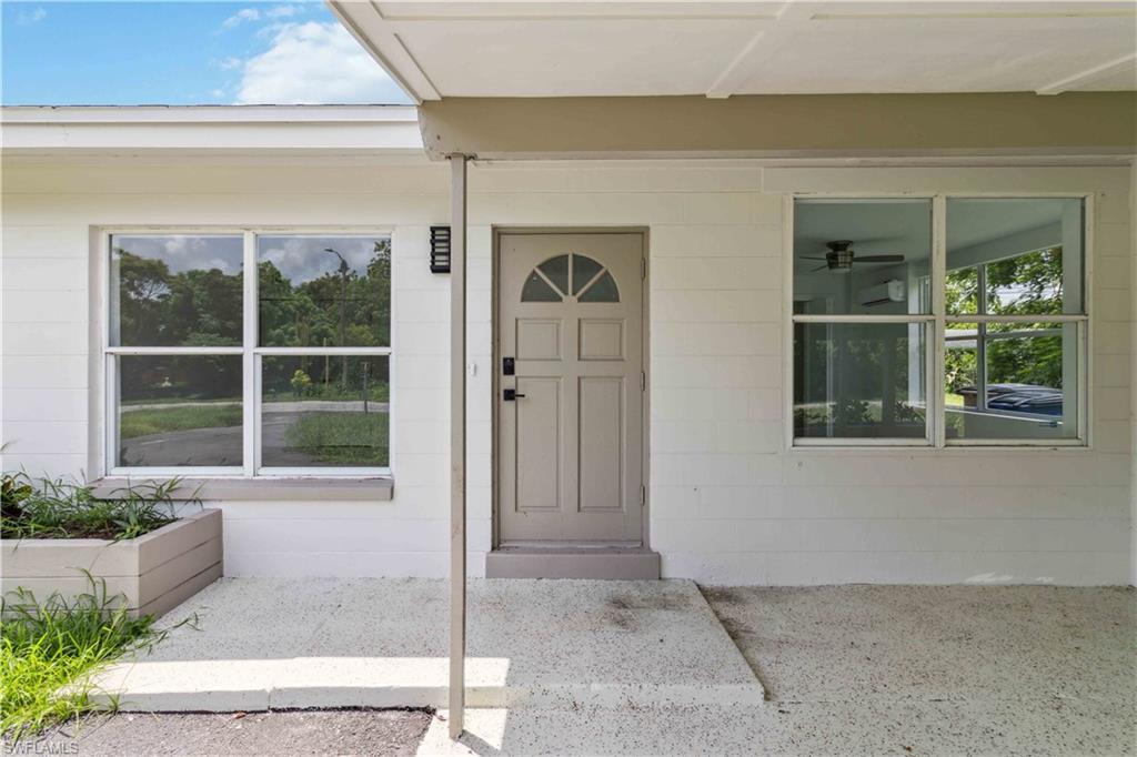 1102 East Bougainvillea Road Lehigh Acres, FL 33936 - Photo 3 of 28 a front view of a house with a yard