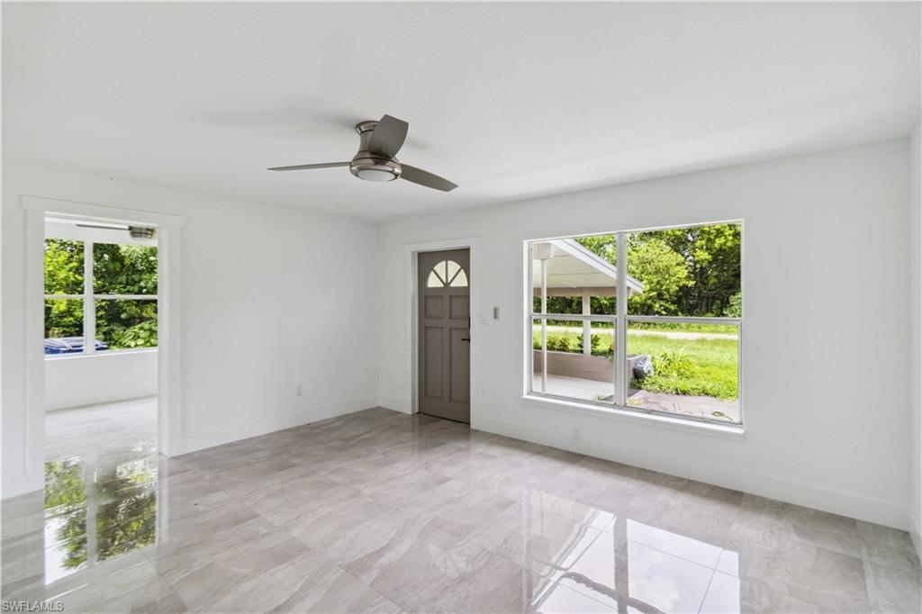 1102 East Bougainvillea Road Lehigh Acres, FL 33936 - Photo 5 of 28 a view of an empty room with a window