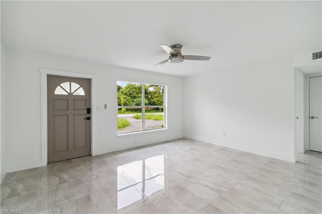 1102 East Bougainvillea Road Lehigh Acres, FL 33936 - Photo 6 of 28 an empty room with windows and closet