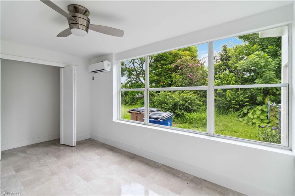 1102 East Bougainvillea Road Lehigh Acres, FL 33936 - Photo 9 of 28 an empty room with large windows