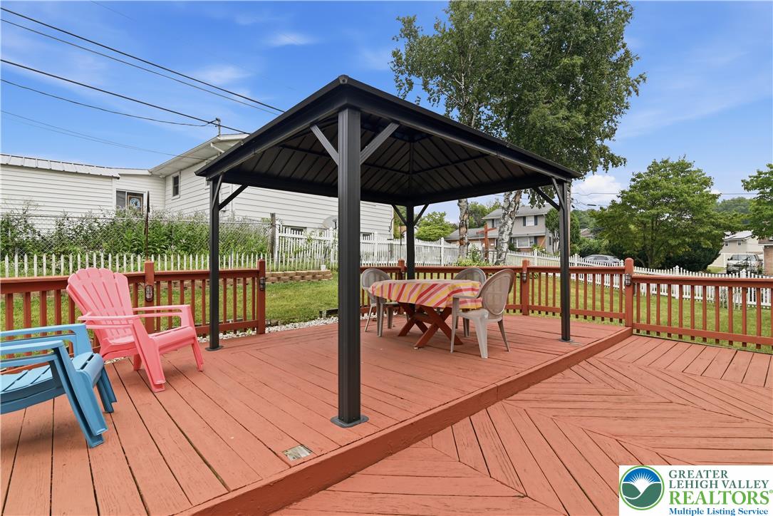 3303 Barklay Road Whitehall, PA 18052 - Photo 35 of 39 An inviting deck offers a covered dining area for al fresco enjoyment, surrounded by a charming picket fence.