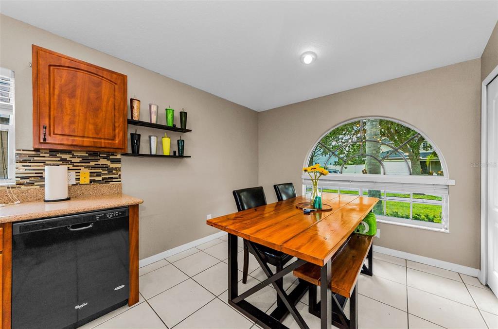 13561 Fladgate Mark Drive Riverview, FL 33579 - Photo 19 of 65 a dining room with a table and chairs