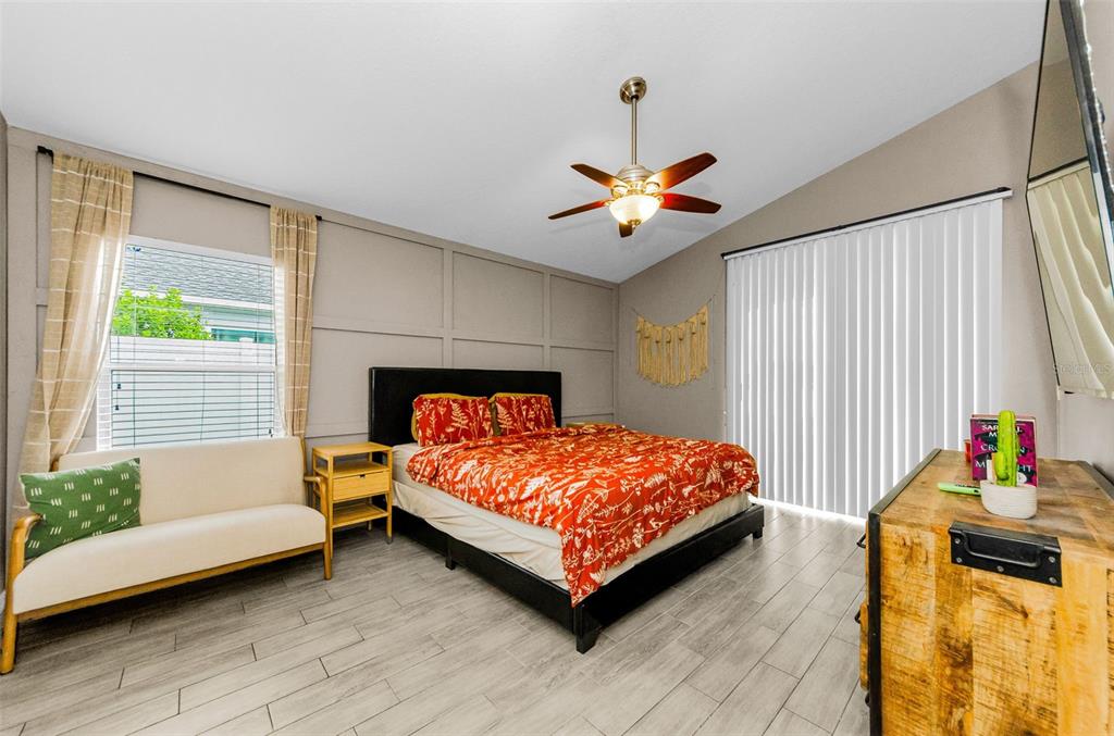 13561 Fladgate Mark Drive Riverview, FL 33579 - Photo 21 of 65 a bedroom with a bed and a chandelier