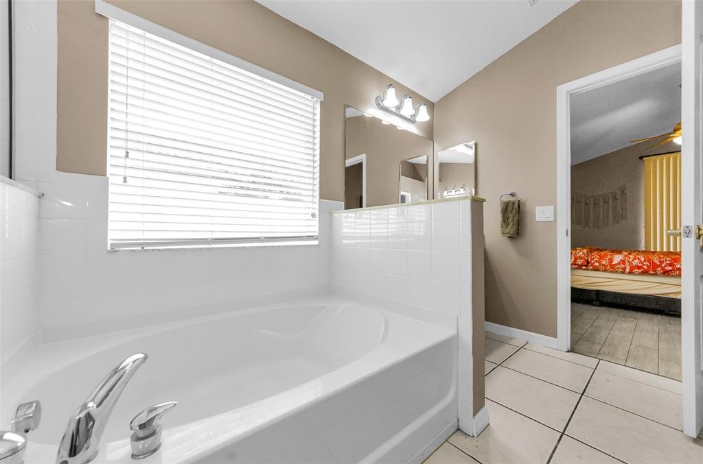 13561 Fladgate Mark Drive Riverview, FL 33579 - Photo 24 of 65 a bathroom with a bathtub and a shower