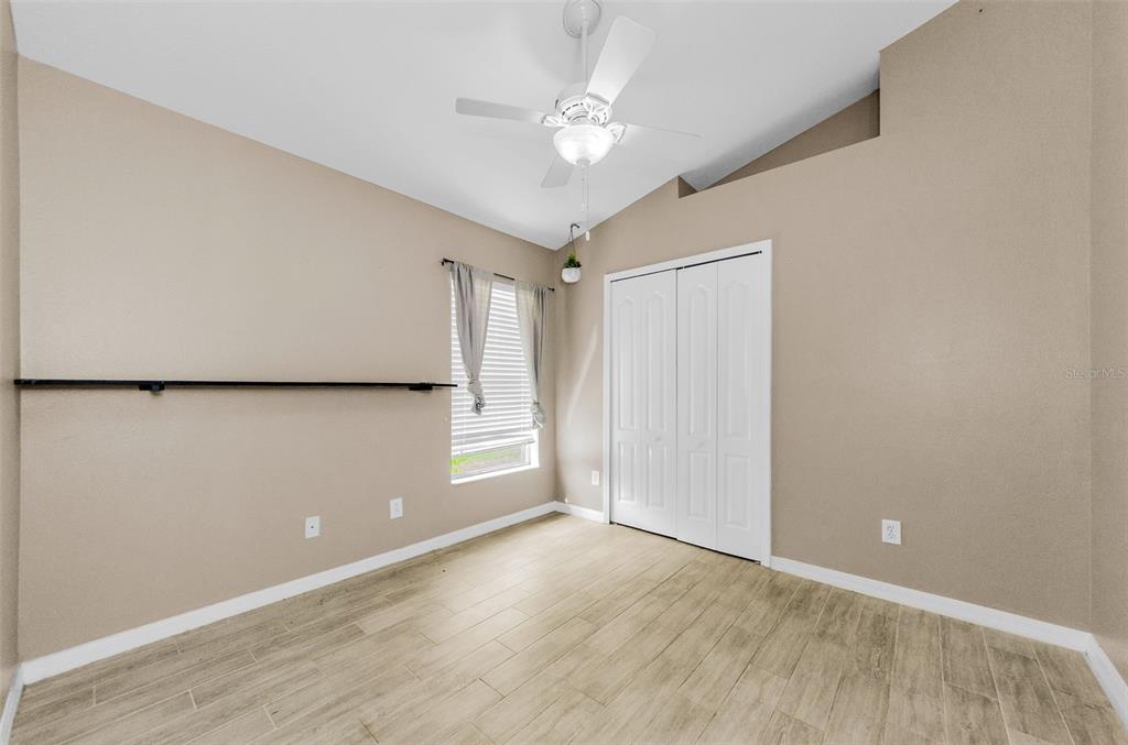 13561 Fladgate Mark Drive Riverview, FL 33579 - Photo 31 of 65 wooden floor in an empty room with a window