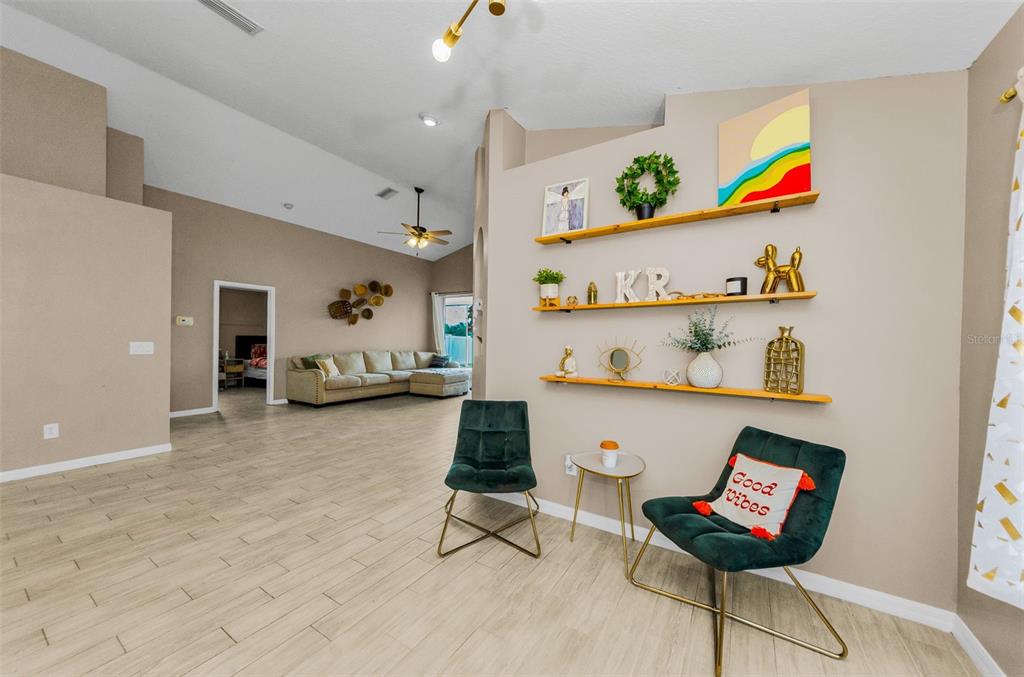 13561 Fladgate Mark Drive Riverview, FL 33579 - Photo 10 of 65 a living room with furniture and a night stand