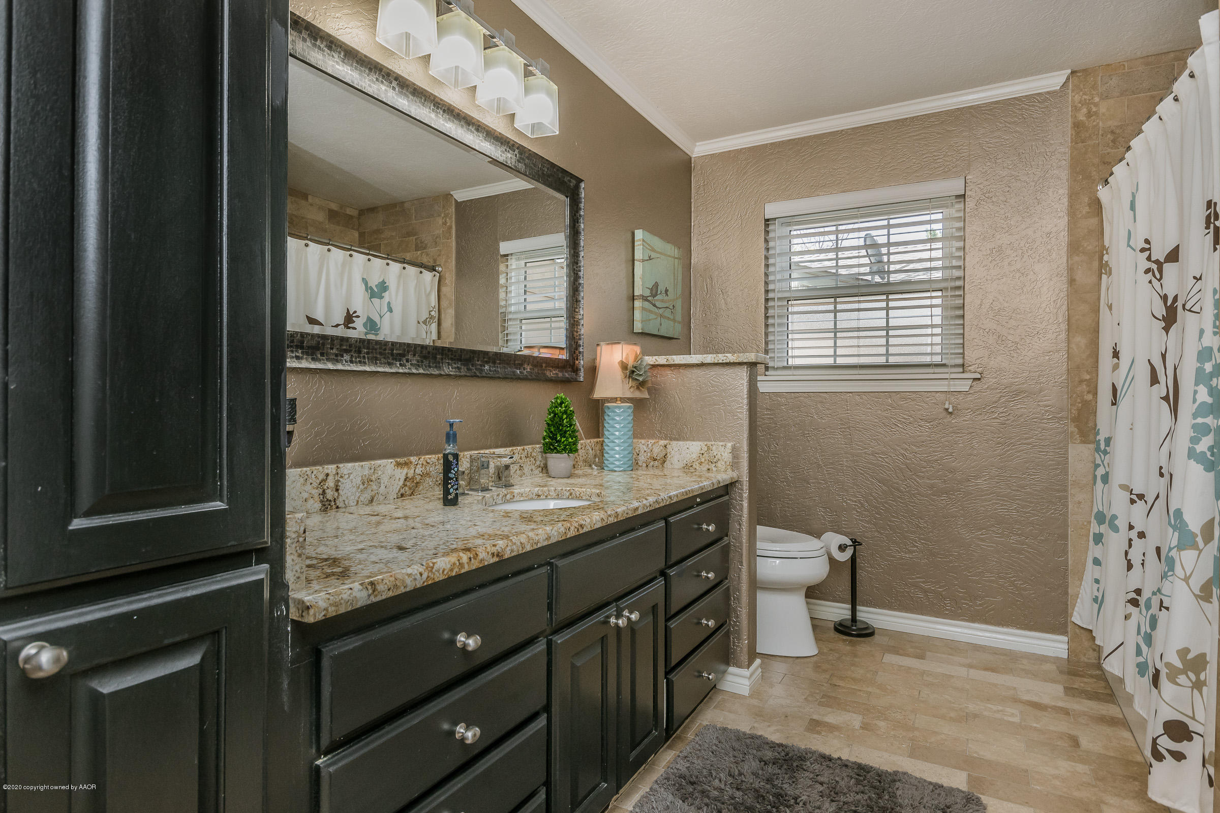 6304 Dreyfuss Road Amarillo, TX 79106 - Photo 22 of 37 a bathroom with a granite countertop sink a mirror and a shower