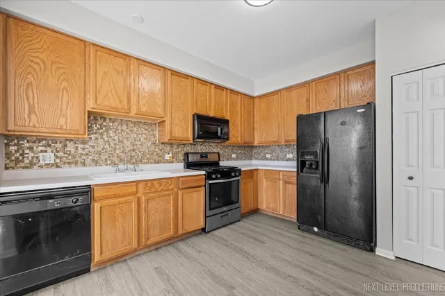 a kitchen with a sink stove and refrigerator