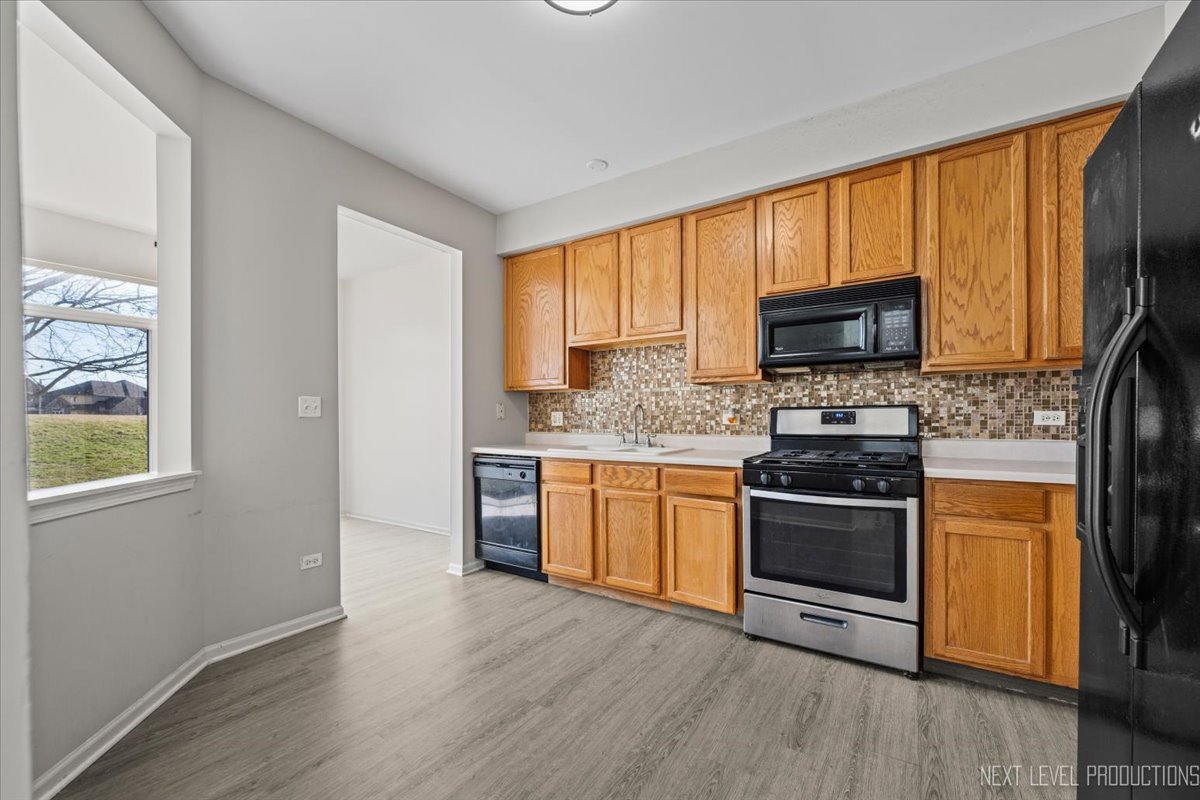 2819 White Thorn Circle Naperville, IL 60564 - Photo 12 of 23 a kitchen with stainless steel appliances granite countertop a stove a sink and a microwave
