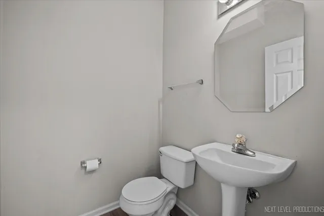 a white toilet sitting next to a bathroom sink
