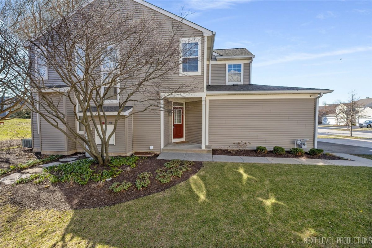 2819 White Thorn Circle Naperville, IL 60564 - Photo 2 of 23 a front view of a house with a yard and garage
