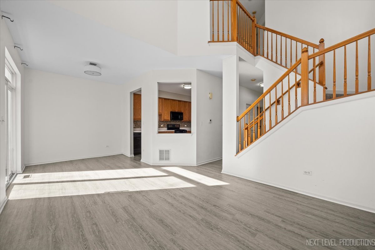 2819 White Thorn Circle Naperville, IL 60564 - Photo 4 of 23 a view of a hallway with wooden floor and staircase