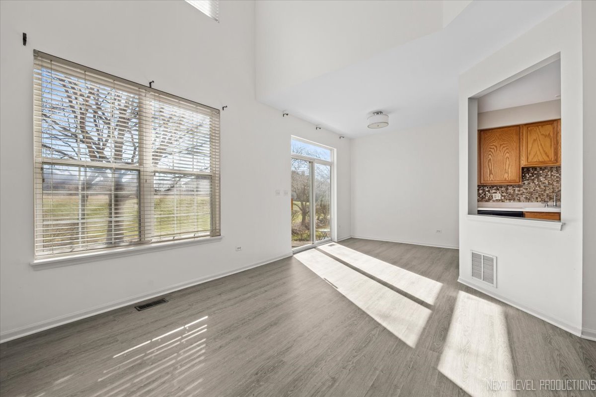 2819 White Thorn Circle Naperville, IL 60564 - Photo 8 of 23 a view of an empty room with wooden floor and a window