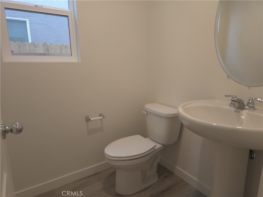 959 Pico Place Chico, CA 95973 - Photo 3 of 19 a white toilet sitting next to a bathroom sink