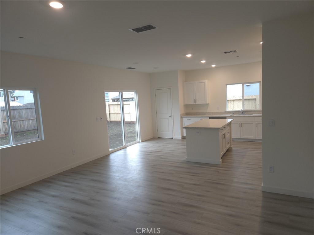 959 Pico Place Chico, CA 95973 - Photo 4 of 19 an empty room with wooden floor and windows