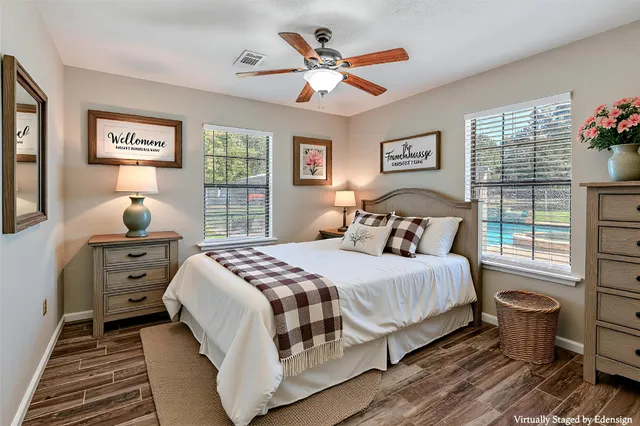 a bedroom with a bed and wooden floor