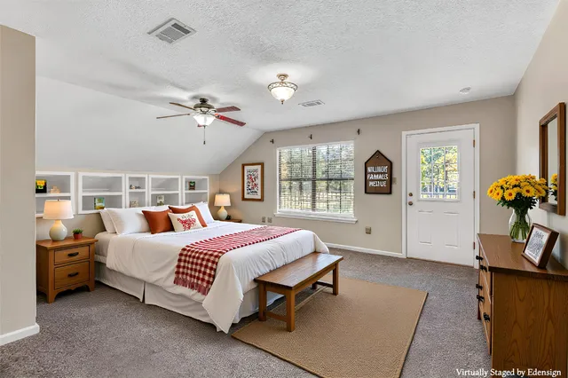 a bed room with a bed mirror and a chandelier