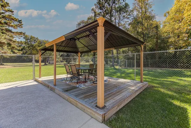 a view of a kitchen with wooden floor and a window
