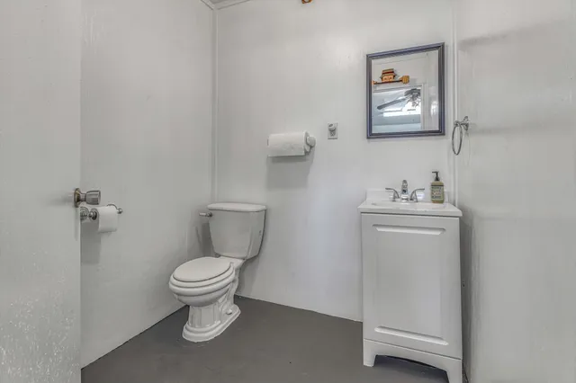 a view of wooden floor and chandelier fan in a room