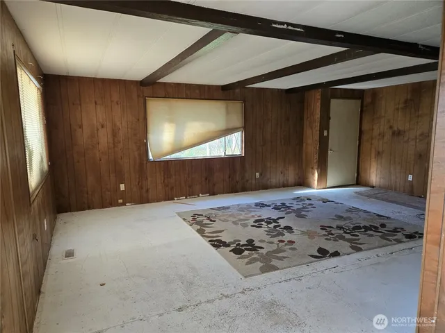 a view of an empty room and a window