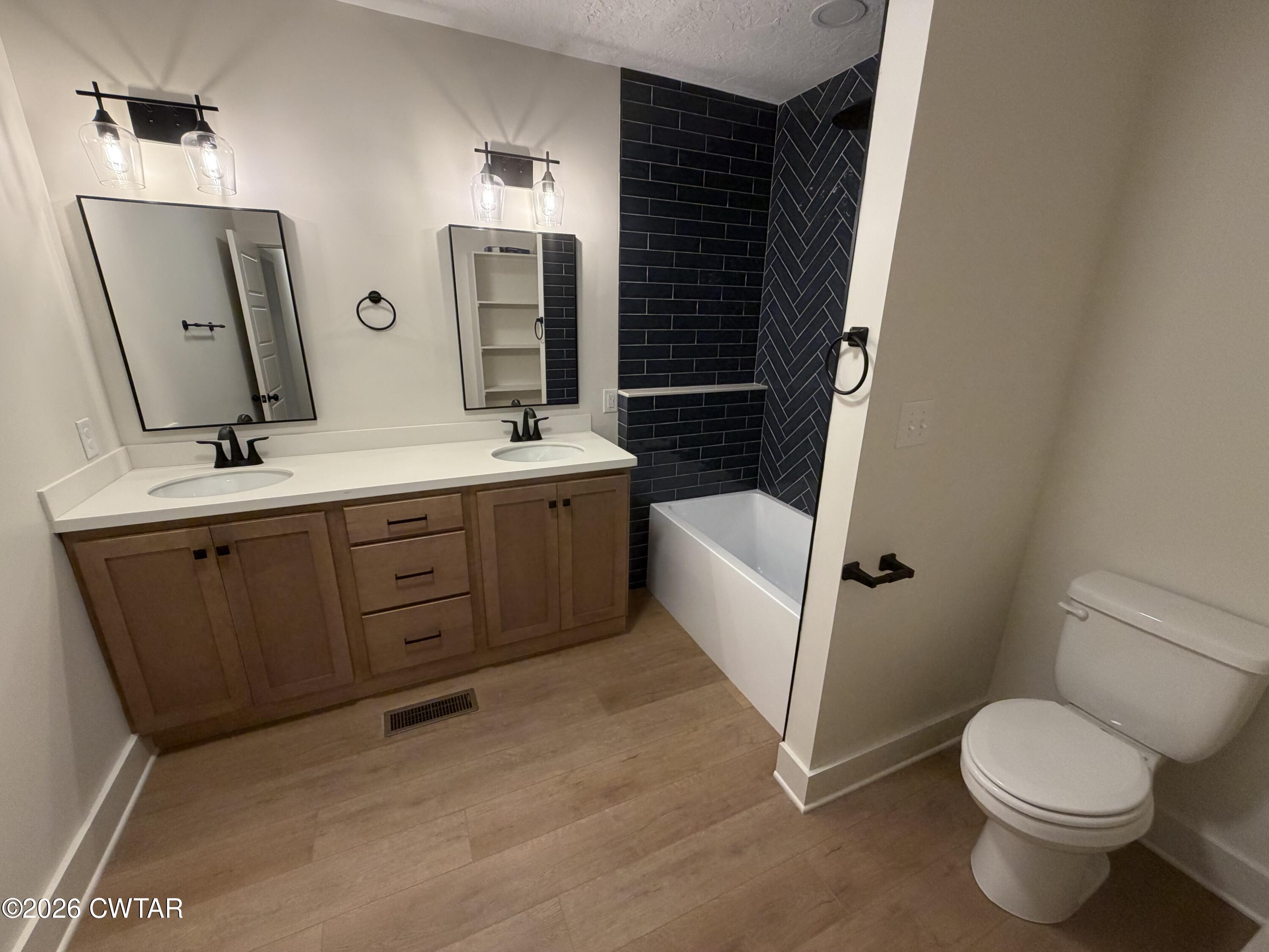 16 Manner Frank Road Milan, TN 38358 - Photo 17 of 25 a bathroom with a sink a toilet and mirror