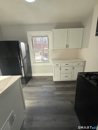 a kitchen with cabinets and steel appliances