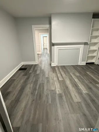 a view of an empty room and wooden floor