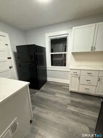a kitchen with a refrigerator and cabinets