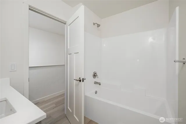 a front view of a house with a garden and parking