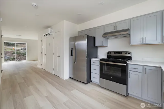 a stove top oven sitting inside of a kitchen