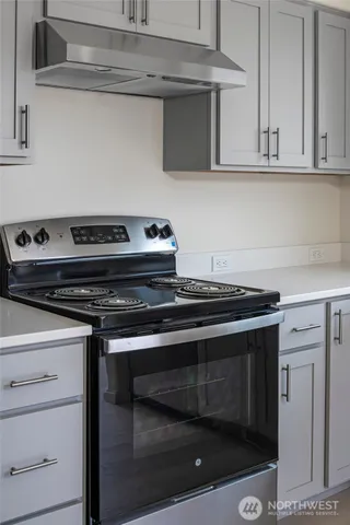 a kitchen with a sink cabinets and stainless steel appliances
