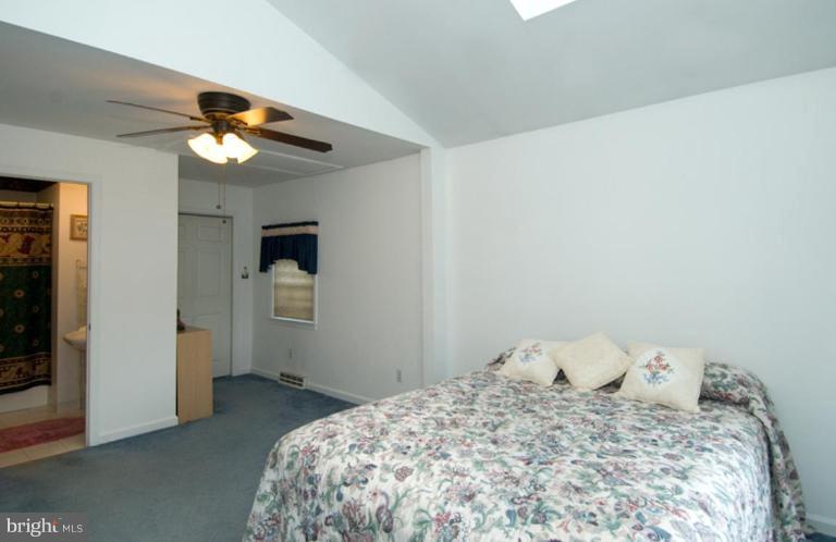 508 Grovethorn Road Middle River, MD 21220 - Photo 11 of 19 a bedroom with a bed and a chandelier