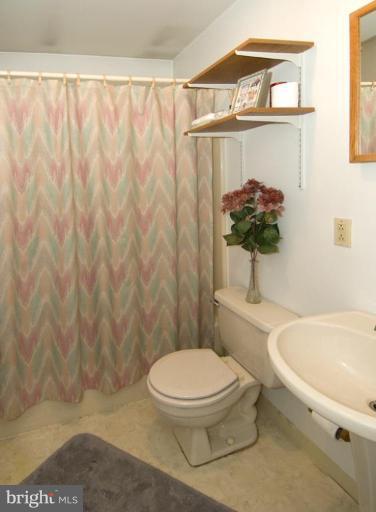 508 Grovethorn Road Middle River, MD 21220 - Photo 14 of 19 a white toilet sitting next to a bathroom sink and vanity