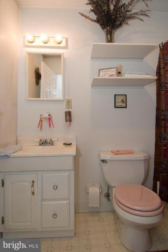 508 Grovethorn Road Middle River, MD 21220 - Photo 15 of 19 a bathroom with a toilet a sink and mirror