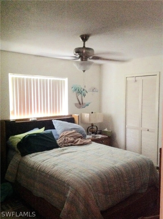 25 Michigan Road Lehigh Acres, FL 33936 - Photo 13 of 16 a bedroom with a bed and a chandelier