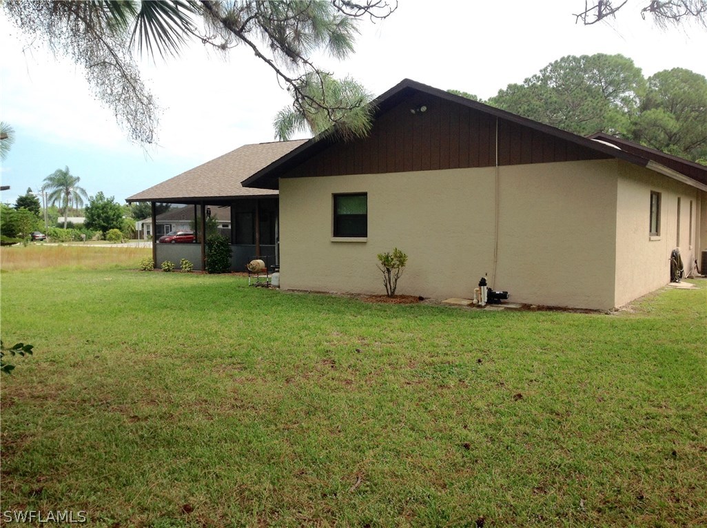 25 Michigan Road Lehigh Acres, FL 33936 - Photo 4 of 16 a view of a house with backyard and garden