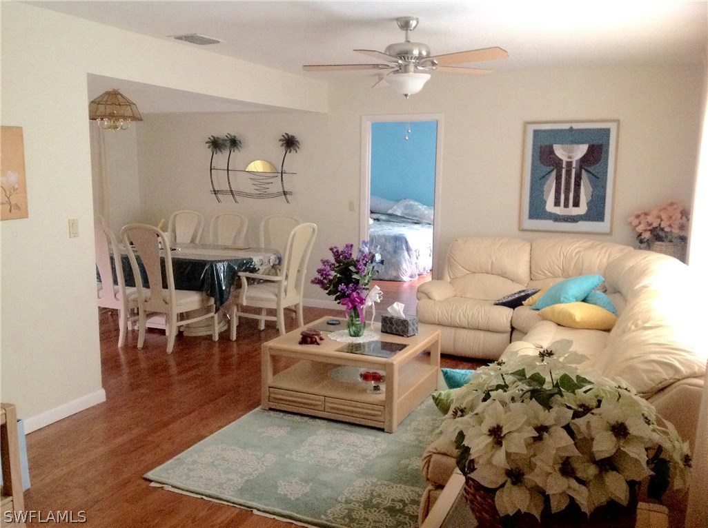 25 Michigan Road Lehigh Acres, FL 33936 - Photo 5 of 16 a living room with furniture and wooden floor