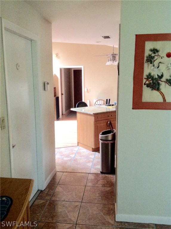 25 Michigan Road Lehigh Acres, FL 33936 - Photo 6 of 16 a kitchen with stainless steel appliances granite countertop a refrigerator and a stove
