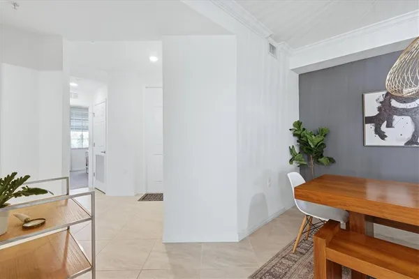 a view of a room that has a table and a potted plant