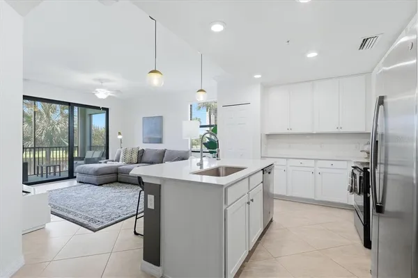 a kitchen with a sink stove and refrigerator