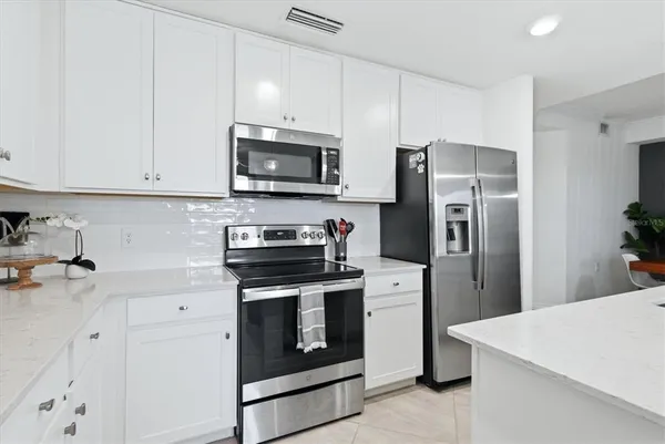 a kitchen with cabinets stainless steel appliances and wooden cabinets