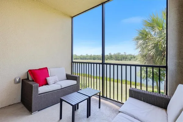 a balcony with furniture and a potted plant
