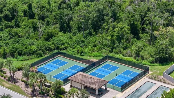 an aerial view of a house with swimming pool and a yard