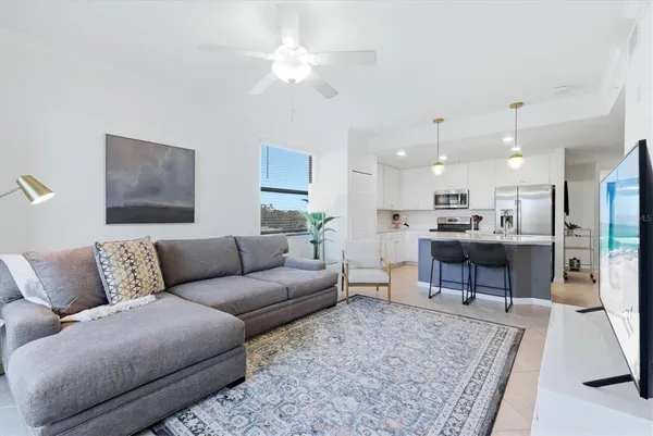 a living room with furniture kitchen view and a table